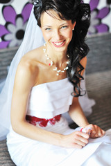 Fototapeta premium Young beautiful bride getting ready and smiling