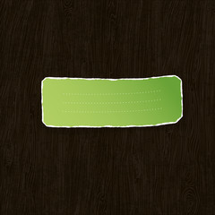 Green torn label on wooden texture. Vector illustration, EPS10
