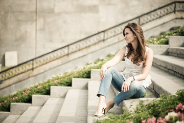 Portrait of a beautiful european woman sitting om steps