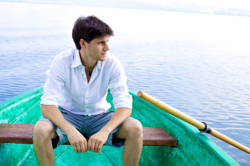 Fototapeta premium Handsome man relaxing on boat