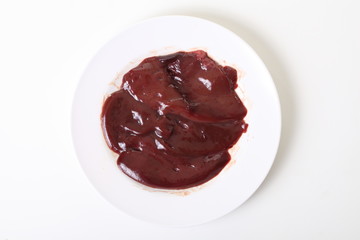 Slide of fresh and raw pork liver on dish