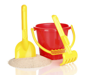 Children's beach toys and sand isolated on white