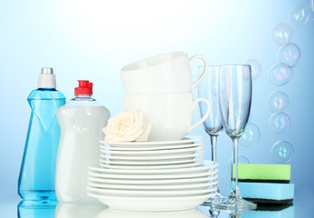 empty clean plates, glasses and cups with dishwashing liquid