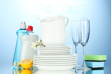 empty clean plates, glasses and cups with dishwashing liquid,