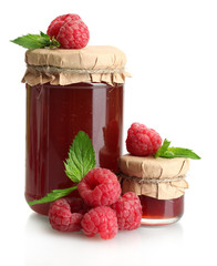 jars with jam and ripe raspberries with mint isolated on white