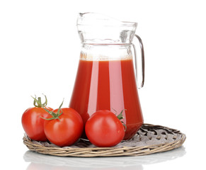 Tomato juice in pitcher on wicker mat isolated on white