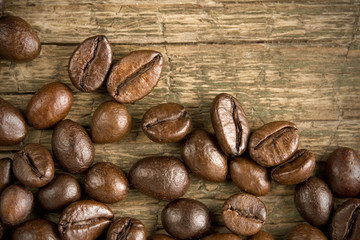 Coffee beans on the wooden vintage background