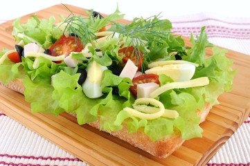 Appetizer of chicken with egg and olives on ciabatta