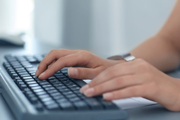 Fototapeta na wymiar Close-up of typing female hands