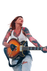 Attractive punk girl with tattoos playing electrical guitar