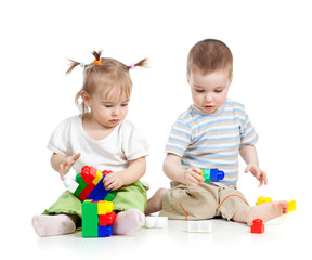 little children playing together with colorful toy over white ba