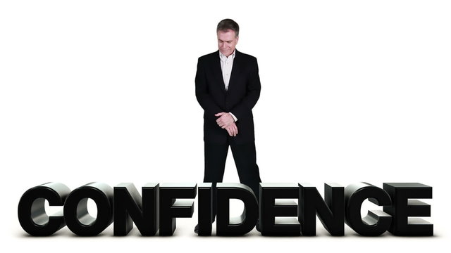 Businessman standing over confidence word