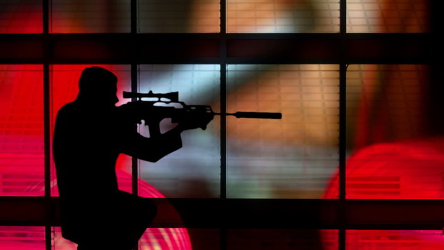 silhouette of a gunman against a colorful background