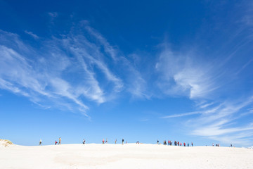 people walking in the big dune, Slowinski National Park, Poland