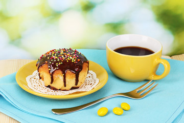 Appetizing cupcake with chocolate on nature background