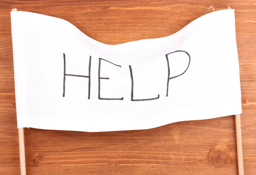 Fototapeta Help written on white cloth on wooden background
