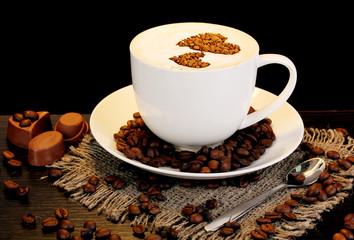 Latte on wooden table on brown background