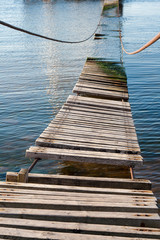 Old suspension bridge over water