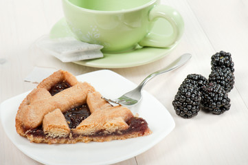slice fruit tart with cup of tea