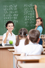 math teacher questions pupils at the chalkboard