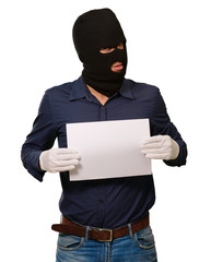 Man wearing a robber mask showing a blank paper