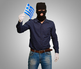 Man wearing robber mask and holding flag
