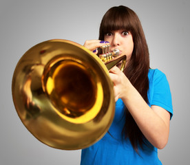 portrait of a young girl blowing trumpet © Krakenimages.com