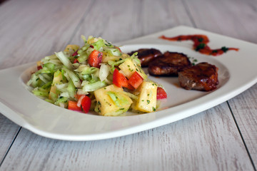 Fresh paprika and pineapple salad with steak