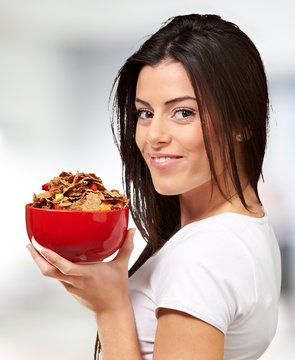 portrait of young woman holding a cereal bowl indoor