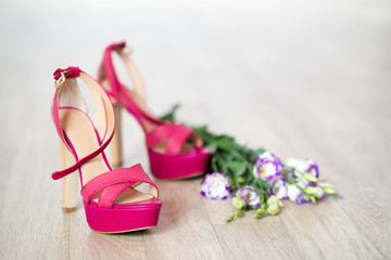 Fashion high heel shoes and flowers close-up