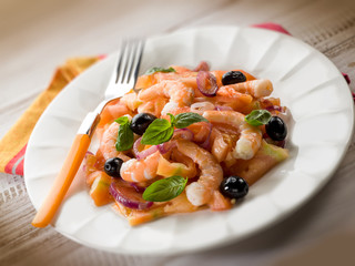 salad with shrimp tomatoes and black olives, selective focus