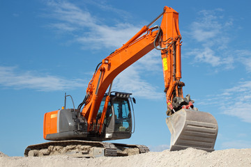 Excavator in gravel quarry site