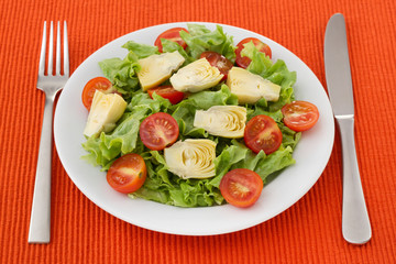 salad with artichoke on the white plate
