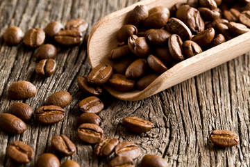 coffee beans in wooden scoop