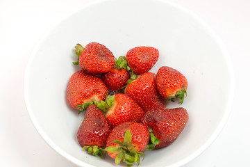 Strawberries in bowl on white