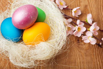 Fototapeta na wymiar Colorful easter eggs on old wooden background
