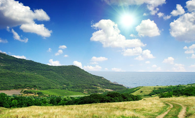 Summer day landscape with the sea and mountains.