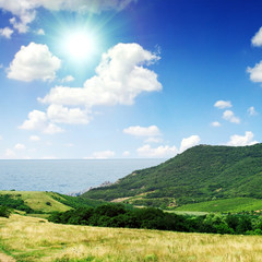 Summer day landscape with the sea and mountains.