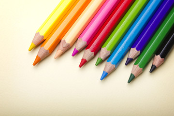 Fototapeta premium Color pencils crayons on paper background