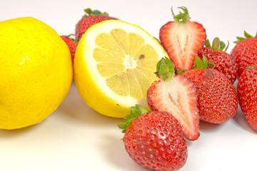 Fototapeta na wymiar Lemons and strawberries on white