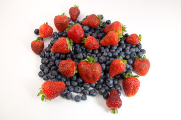 Strawberries and blueberries on white