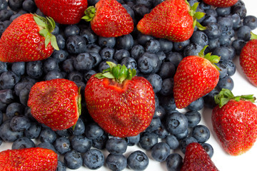 Fototapeta na wymiar Blueberries and strawberries on white