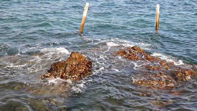 Sea waves slide to stones