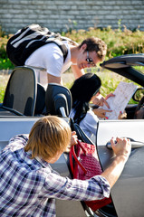 Male thief stealing handbag, accomplice distracts female driver
