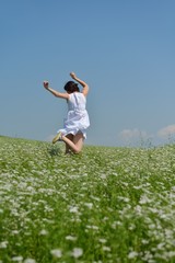 Young happy woman in green field