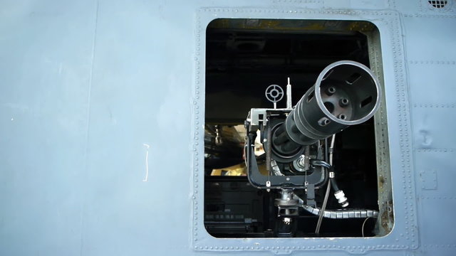 Gatling or rotary gun mounted in a helicopter. Camera move.