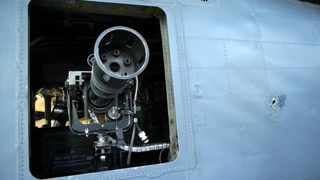 Gatling or rotary gun mounted in a helicopter. Camera move.