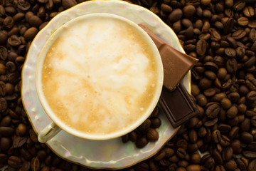 Cup of cappuccino on plate