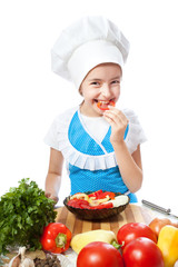 Happy little chef cook tastes salad with Bell Pepper
