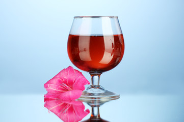 glass with cocktail and gladiolus bud